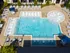 Aerial photograph of the pool area at our apartments in Atlanta, featuring pool chairs, reclining chairs, and umbrellas.