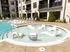 The pool lounge at our apartments for rent in Atlanta, featuring chairs in the pool and a view of the apartment complex.