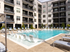 The pool area at our apartments in Atlanta, featuring pool chairs, beach chairs, and a view of the apartments.