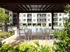 Outdoor lounge at the pool at our apartments in Atlanta, featuring a shade structure with chairs and tables under it.