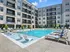 The pool area at our apartments in Atlanta, featuring pool chairs, beach chairs, and a view of the apartments.