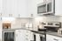 Kitchen - oven, stove top, wine fridge, light cabinets