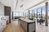 Sky Lounge with kitchen island, and soft seating and view of downtown