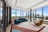 Sky lounge with soft seating and floor to ceiling windows with downtown view