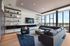 Sky Lounge with soft seating around a TV and floor to ceiling windows