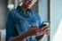 Woman in denim shirt looking at phone