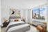 Classic primary bedroom with a view of the city