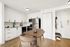 Classic apartment kitchen with white cabinetry and stainless steel appliances