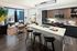 Modern kitchen with an island for entertaining featuring stainless steel appliances
