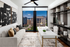 Living area with floor-to-ceiling windows w/ stunning skyline view