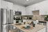 Close up of corner kitchen with island, stainless steel appliances, and ample cabinets