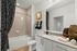 Bathroom with tub and single vanity