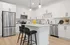 Modern Designer Kitchens with Quartz Countertops and Glass-Tiled Backsplash featuring an Island for Entertaining