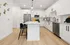 Modern Designer Kitchens with Quartz Countertops and Glass-Tiled Backsplash featuring an Island for Entertaining