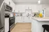 Modern Designer Kitchens with Quartz Countertops and Glass-Tiled Backsplash featuring an Island for Entertaining
