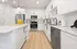 Modern Designer Kitchens with Quartz Countertops and Glass-Tiled Backsplash featuring an Island for Entertaining