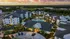 Aerial image of Marlowe Gateway including clubhouse, buildings and pool courtyard, with a sunset sky and the city of Tampa far off in the distance