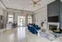 Lobby and lounge at our apartments in Charlotte, featuring couches, rugs, tiled floors, and a flat screen TV.