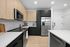 Unit interior kitchen, quartz countertops, dual tone cabinets, designer backsplah