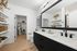 Bathroom with elevated finishes to include quartz counters, oversized mirror, oversized closet, and matte black finishes