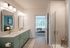 Bathroom with double vanity sinks and stand alone shower
