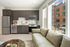 Brown cabinetry and custom tile backsplash