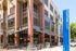 Vibrant exterior of FountainCourt complex featuring modern architecture and inviting outdoor seating.
