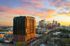 Drone image of exterior building with Charlotte skyline in the near distance at Kingston South End Apartments
