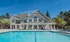 Large pool in front of the clubhouse, surrounded by beautiful landscape.