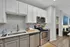 Modern kitchen with sleek appliances, elegant cabinetry, and stylish hexagonal backsplash, showcasing open-concept design.