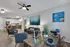 Inviting open-concept living space with modern kitchen, cozy lounge area, and stylish dining setup, perfect for social gatherings.