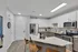 Modern kitchen with sleek stainless steel appliances, stylish white cabinetry, and elegant countertops, ideal for contemporary living.