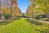 Charming autumn landscape featuring lush green lawns and vibrant foliage in a serene apartment community setting.