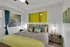 Cozy bedroom with chic decor, featuring contemporary art pieces, elegant bedside lamps, and stylish accent pillows, perfect for modern living.