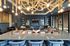 Table seating and detailed light fixture in resident lounge at Beckon