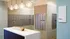 Elegant mailroom featuring modern mailboxes and stylish lighting in a contemporary apartment building.