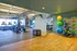 Vibrant fitness room with modern exercise equipment, colorful yoga balls, and inspiring wall art, offering a dynamic workout environment.
