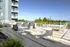 Elegant rooftop deck with stylish seating areas, barbecue grills, and ocean view, perfect for entertaining and relaxation.