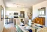 Bright and modern kitchen and dining area featuring sleek appliances, a stylish glass table set for dining, and elegant decor in a cozy atmosphere.