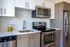Modern kitchen with sleek stainless steel appliances, elegant cabinetry, and a bright, inviting atmosphere.