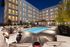 Pool with seating and fire pit at night