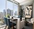 Modern apartment interior with elegant dining area, plush seating, and panoramic city views through large windows.
