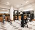 Modern fitness center with state-of-the-art exercise equipment, sleek design, and mirrored walls for a dynamic workout environment.