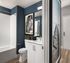 Sophisticated bathroom with modern fixtures, elegant wall art, and a sleek white bathtub offering a perfect blend of style and comfort.