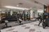 Modern, well-equipped gym with state-of-the-art fitness machines and free weights, ideal for an upscale apartment lifestyle.