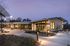 Clubhouse exterior lit at dusk with landscaped paths at Sonora in Austin, TX