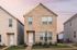 Detached rental home with brick facade and green lawn at Sonora Gardens, Sonora in Austin, TX