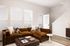 Living room with brown sectional sofa and soft lighting at Sonora in Austin, TX