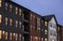 Apartment building exterior with brick facade at dusk at The Court, Sonora in Austin, TX