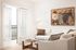 Living room with white sofa and balcony doors at Sonora in Austin, TX